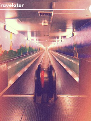An underground escalator with colourful artwork of people and gardens (left of screen)