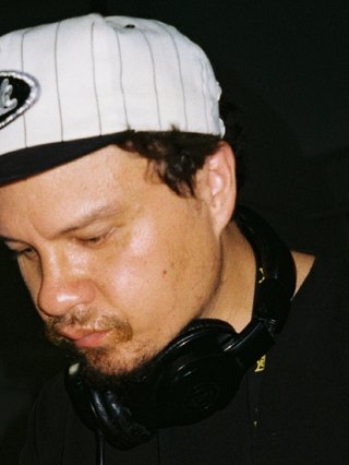 Scruffs with with headphones and a cap on