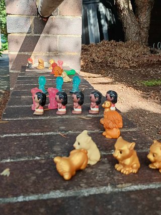 little coles toys in rows left for taking out front of a home