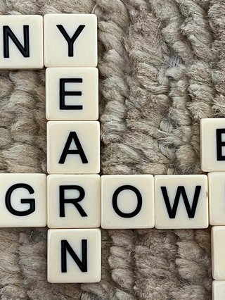 Scrabble letters with the words: yearn and growl