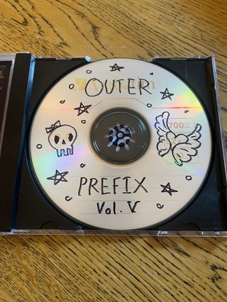 Hand-drawn artwork on a CD copy of 'Outer Prefix V' compiled by Lindsey Vassallo