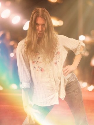 Jim hitting a stylish pose, edited onto a red carpet scene.