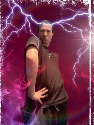 A heavily edited picture of Jim making a bold pose. The background is maroon and the picture features lightning, coloured smoke, lens flare and a tasteful white border.