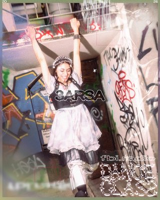 3arsa posing, surrounded by walls covered by graffiti