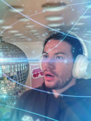 A highly edited photo of Jim staring in wonder at a disco ball.