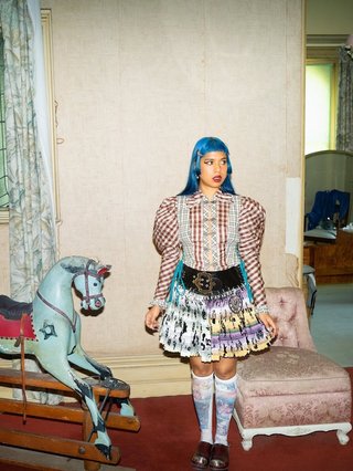 Blue hair girly next to rocking horse