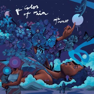 aja monet lying down, surrounded by flowers in hues of purple and blue