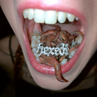 A closeup of aya's open mouth - inside are worms and a silver engraving of the album title 'hexed!'