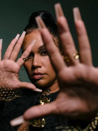 BARKAA two hands up in front of her face