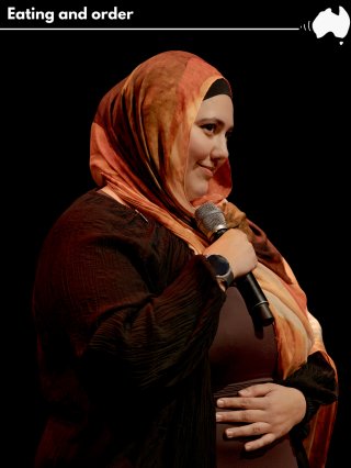 A smiling middle eastern lady wearing a Keffiyeh holds her belly