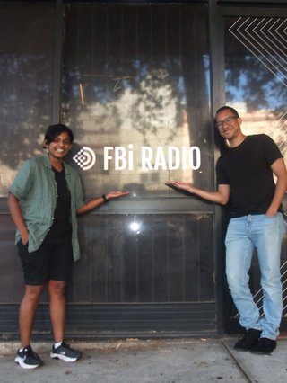 Hosts Kwame and Mads stand outside fbi radio.