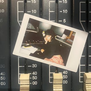 A polaroid of Ella Avni in the studio on top of the mixer which is also located in the studio.