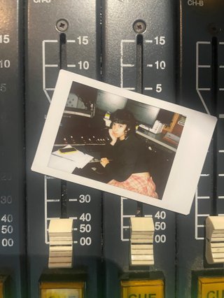 A polaroid of Ella Avni in the studio on top of the mixer which is also located in the studio.