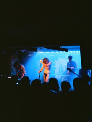 A film photo of the band G.U.N. performing at the Landsdowne, bathed in blue light