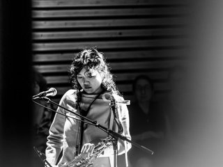 A black and white photograph of Hinano playing saxophone at Phoenix Central Park