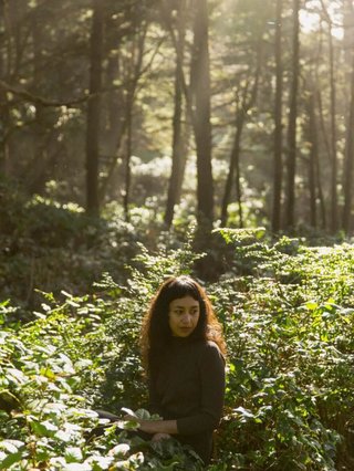 Haley Heynderickx. Woman standing in forest