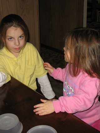 Two young girls at a dining table.