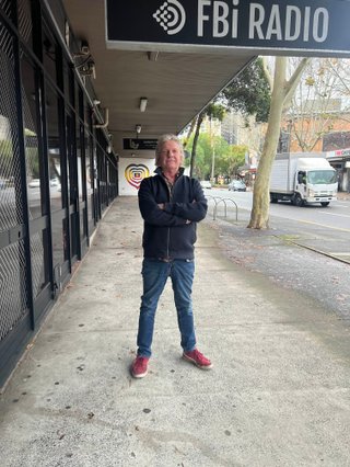 Charlie Owen standing in front of the fbi radio station