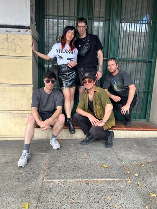 Members of screensaver standing in front of the fbi radio building