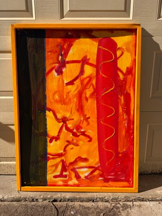 Image of a garish yellow, red and murky green painting on a road sign.