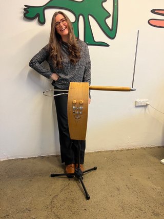 Carolina Stands smiing behind her Moog Theremin