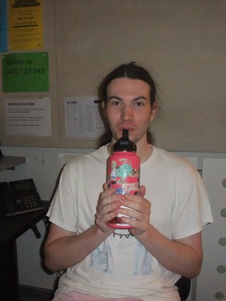 Jim Kretschmer is drinking water in the studio.