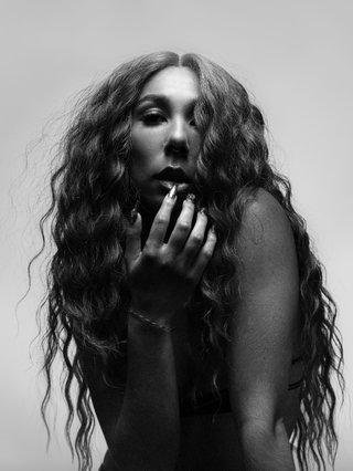 A black and white photo of Miss Kaninna looking at the camera