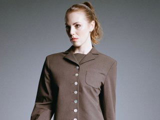 Purient in a brown suit on a grey background