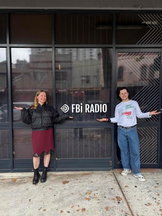 Sam Lane, and fbi presenter stands in front of the fbi radio building with artist Julia Jacklin