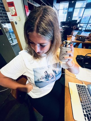 girl wearing t-shirt of virgin suicides movie and holding a sparkly water bottle