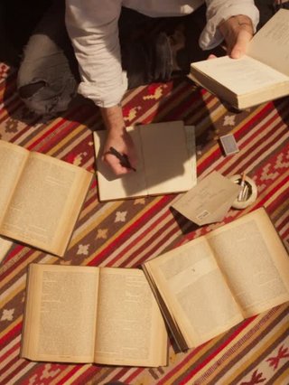 Several pigeons taking flight into a daytime blue sky.