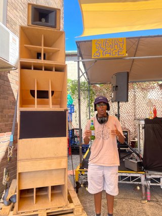 Cedar standing behind a soundsystem