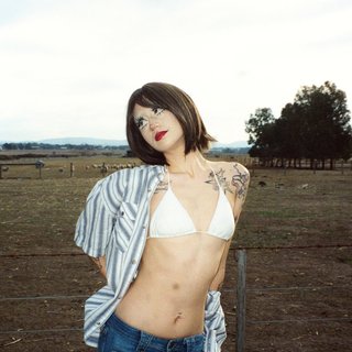 Cherry Rype stands in front of a wire fence on a paddock.