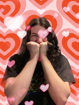 Jim pulling a cute shy pose, edited in front of a background full of hearts.