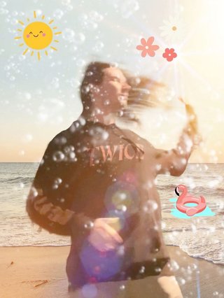 Jim poorly edited into a picture of the beach, with excessive lens flare and summer related stickers plastered all over the image.
