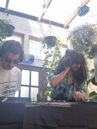 Jonathan and Tommy playing at a fundraiser for Palestine