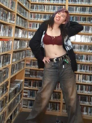 Cappy stands in the corner of FBi's CD library, posed in a silly manner.