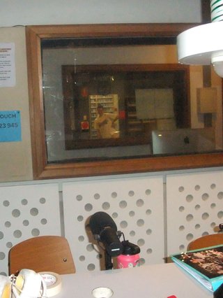 a picture of Jim posing awkwardly in the doorway to fbi's library room. The picture was taken from the studio. There are many layers of glass between those two locations.