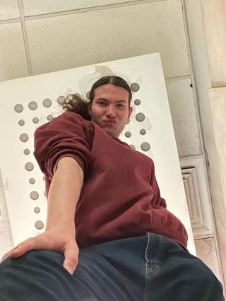 A picture taken from below of Jim posing stylishly.