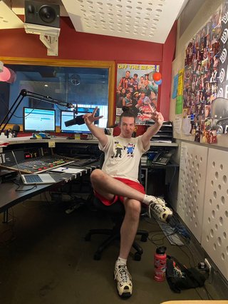 Jim in the studio throwing up two peace signs, generally just being super chill and vibey.
