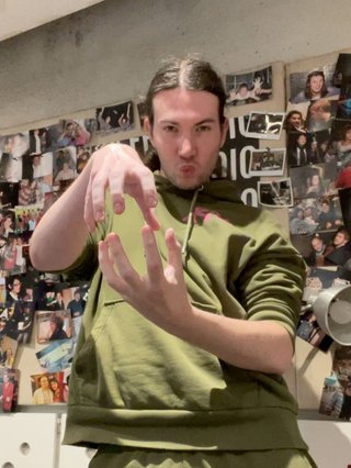 Jim in the studio posing with clawed hands in front of their body, mimicking the choreography of Are You Alive by tripleS.