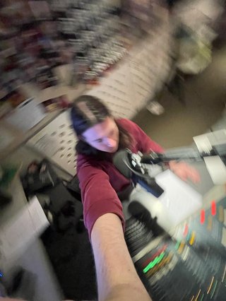 A high angle 0.5x selfie of Jim in the studio.