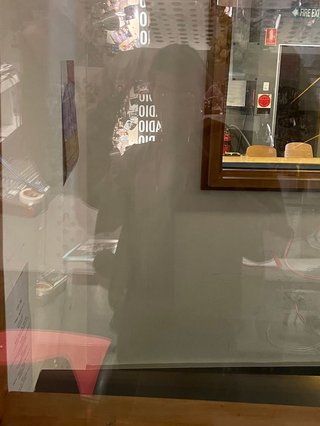 A selfie of Jim taken in the reflection of the window of the fbi radio studio.