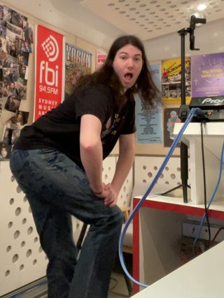 An action shot of Jim throwing their ass back in the fbi studio. Their ass looks perfectly shaped in the jeans they're wearing it's honestly a little distracting.