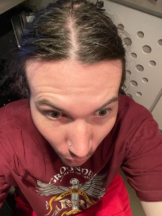 A selfie of Jim that is uncomfortably close and taken from a high angle. It's unflattering to say the least.