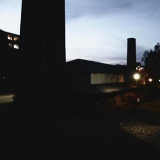 A blurry image of a building at dusk. Shot at low exposure, so its hard to make out much.
