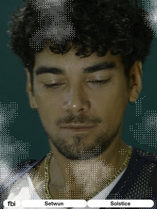 Close up of Josh Panakera-Moloney aka Setwun under low light, eyes looking down with a soft smile. FBi signature tiled effect over his face as Josh stands before a blue-green backdrop.