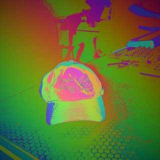 A hat sits on a table, viewed through colourful thermal imaging